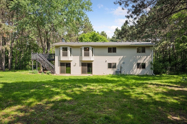 990 221st Ave NW, Oak Grove, MN 55011 - rear view of property featuring stairway, a wooden deck, and a lawn