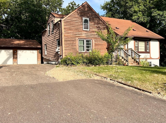 3821 Foss Rd, Saint Anthony, MN 55421 - view of front of home with an outdoor structure, a garage, and a front lawn