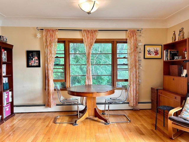 3821 Foss Rd, Saint Anthony, MN 55421 - dining room with plenty of natural light, a baseboard heating unit, and wood finished floors