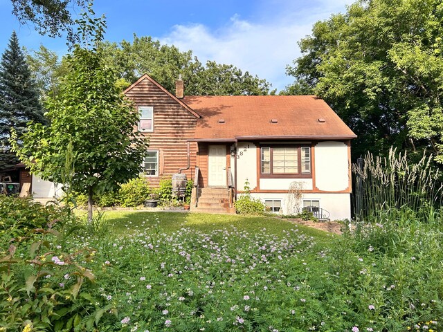 3821 Foss Rd, Saint Anthony, MN 55421 - view of front of property with a chimney and a front lawn