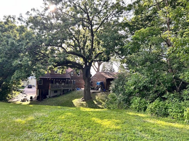3821 Foss Rd, Saint Anthony, MN 55421 - view of grassy yard with a wooden deck