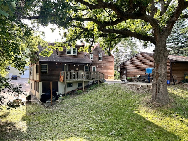 3821 Foss Rd, Saint Anthony, MN 55421 - back of property with a lawn, a patio area, and a deck