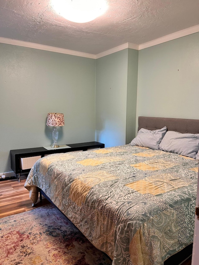 3821 Foss Rd, Saint Anthony, MN 55421 - bedroom featuring wood finished floors, crown molding, and a textured ceiling
