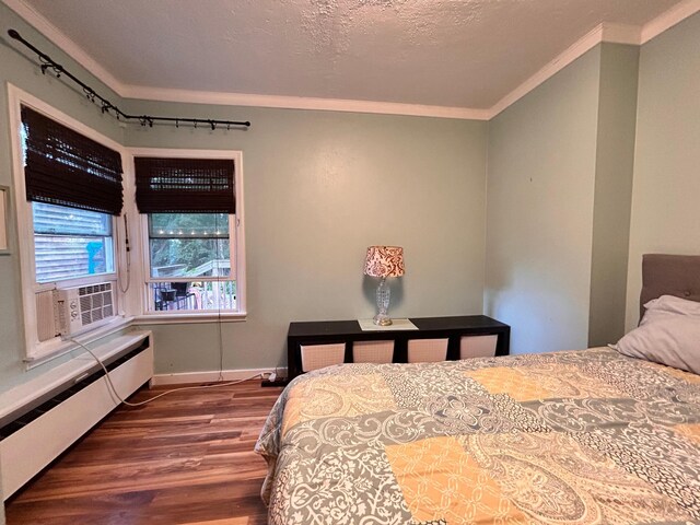 3821 Foss Rd, Saint Anthony, MN 55421 - bedroom featuring crown molding, baseboard heating, wood finished floors, and track lighting