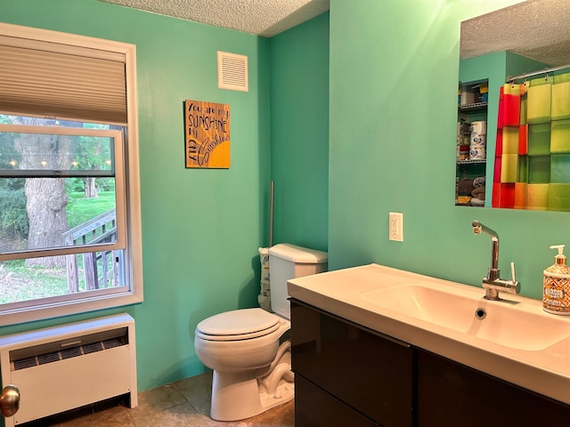 3821 Foss Rd, Saint Anthony, MN 55421 - full bath featuring radiator, a textured ceiling, vanity, plenty of natural light, and a shower with curtain