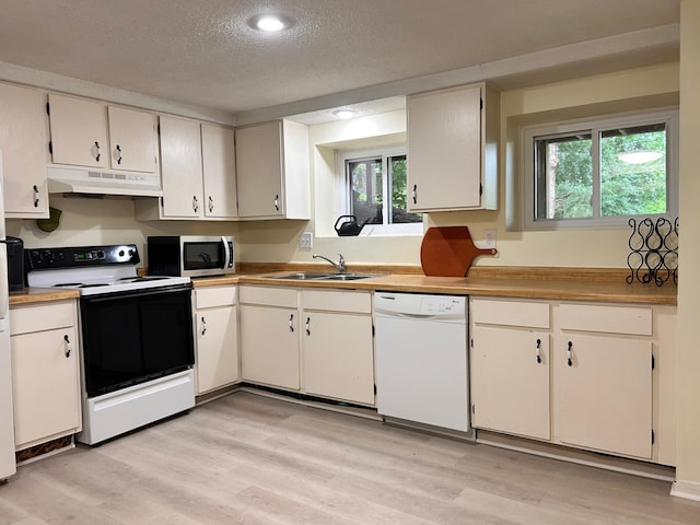 3821 Foss Rd, Saint Anthony, MN 55421 - kitchen featuring white appliances, under cabinet range hood, a textured ceiling, healthy amount of natural light, and light wood-style floors