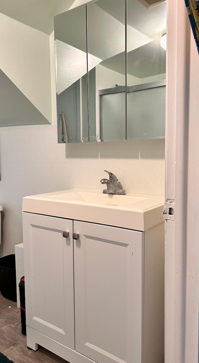 3821 Foss Rd, Saint Anthony, MN 55421 - full bath with vanity, wood finished floors, and an enclosed shower
