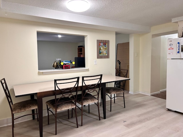 3821 Foss Rd, Saint Anthony, MN 55421 - dining room with light wood finished floors and a textured ceiling