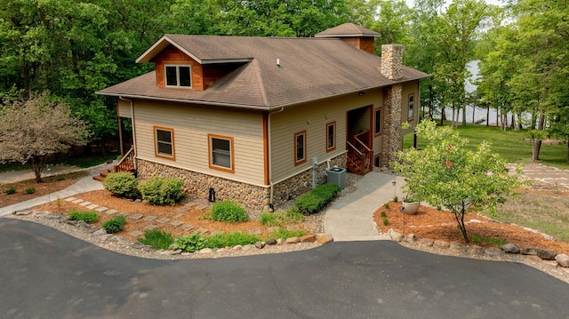 31767 Deacons Way, Pequot Lakes, MN 56472 - view of front of home featuring stone siding, a chimney, stairway, and a shingled roof