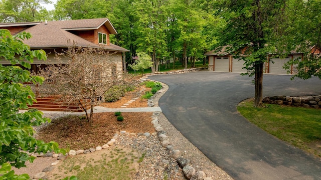 31767 Deacons Way, Pequot Lakes, MN 56472 - view of property exterior with asphalt driveway, a shingled roof, a garage, and an outdoor structure