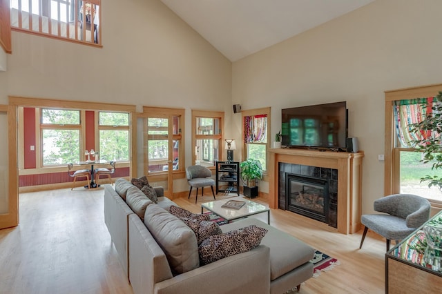31767 Deacons Way, Pequot Lakes, MN 56472 - living room featuring high vaulted ceiling, wood finished floors, and a tile fireplace