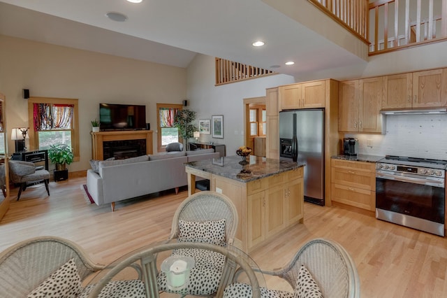 31767 Deacons Way, Pequot Lakes, MN 56472 - kitchen with stainless steel appliances, high vaulted ceiling, light brown cabinetry, light wood-style floors, and plenty of natural light