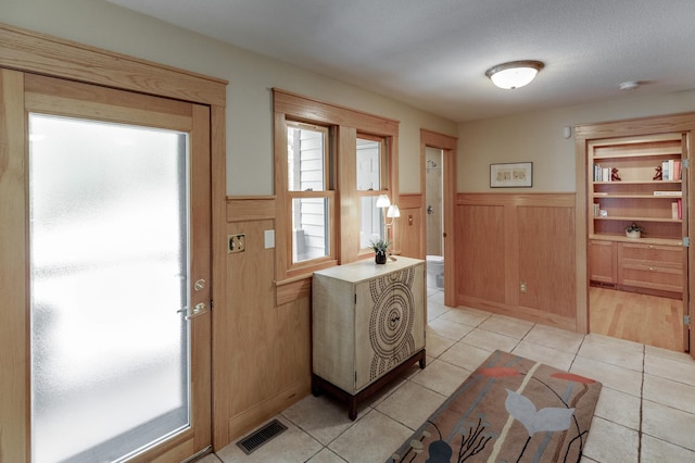 31767 Deacons Way, Pequot Lakes, MN 56472 - entrance foyer with wainscoting and light tile patterned floors