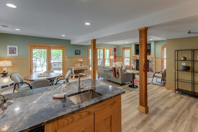 31767 Deacons Way, Pequot Lakes, MN 56472 - kitchen featuring decorative columns, light wood-type flooring, a fireplace, plenty of natural light, and recessed lighting