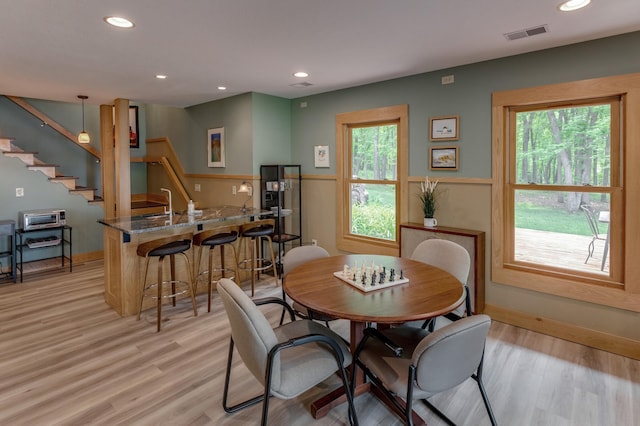 31767 Deacons Way, Pequot Lakes, MN 56472 - dining space featuring light wood-style floors, stairs, recessed lighting, and bar area