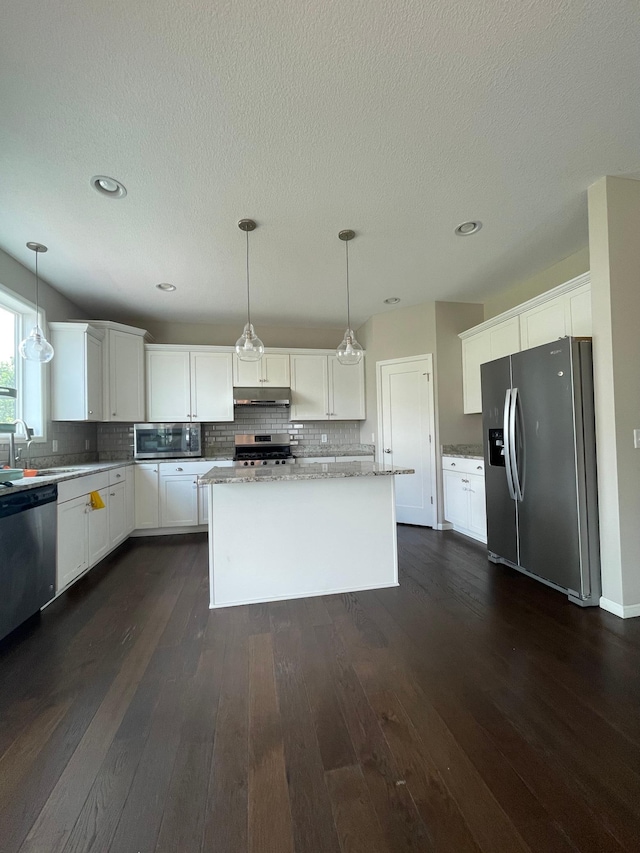5437 154th St W, Apple Valley, MN 55124 - kitchen featuring appliances with stainless steel finishes, under cabinet range hood, decorative backsplash, white cabinets, and recessed lighting