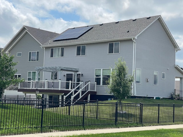5437 154th St W, Apple Valley, MN 55124 - back of property with solar panels, a pergola, a fenced backyard, and roof with shingles