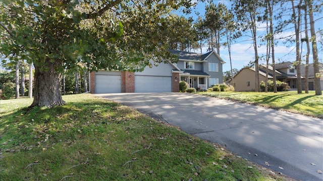 814 8th Ave N, Sartell, MN 56377 - view of front of home with brick siding, driveway, a front yard, and an attached garage