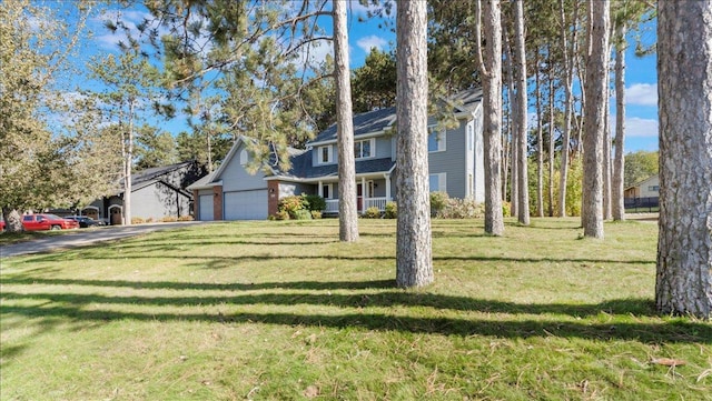 814 8th Ave N, Sartell, MN 56377 - view of front of house with a front lawn, asphalt driveway, and an attached garage