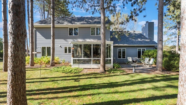814 8th Ave N, Sartell, MN 56377 - back of property with a sunroom, a yard, a patio area, a chimney, and roof with shingles