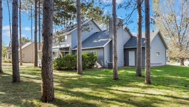 814 8th Ave N, Sartell, MN 56377 - view of side of property with a yard, a shingled roof, and a chimney