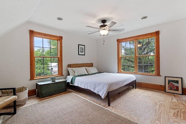 33245 Teal Ave, Shafer Twp, MN 55074 - bedroom with multiple windows, lofted ceiling, a ceiling fan, and wood finished floors