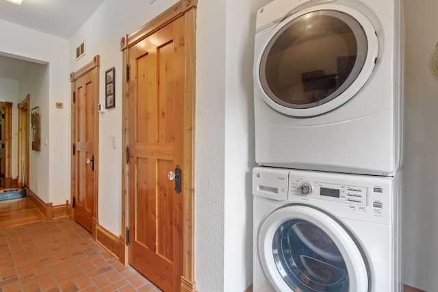 33245 Teal Ave, Shafer Twp, MN 55074 - laundry area with stacked washer / drying machine and brick patterned flooring