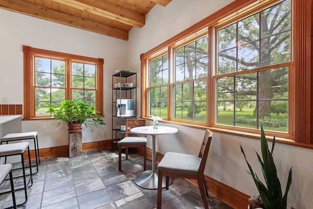 33245 Teal Ave, Shafer Twp, MN 55074 - living area with a wooden ceiling with exposed beams, healthy amount of natural light, and stone tile floors
