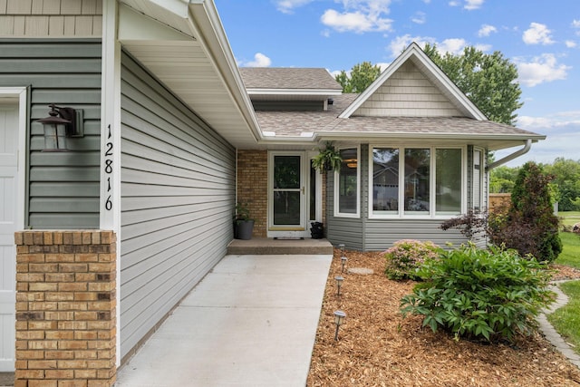12816 95th Ave N, Maple Grove, MN 55369 - view of exterior entry featuring a shingled roof
