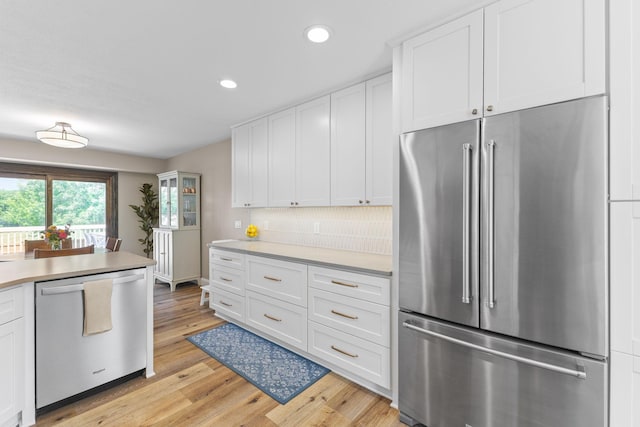 12816 95th Ave N, Maple Grove, MN 55369 - kitchen featuring stainless steel appliances, light countertops, white cabinetry, light wood-style flooring, and recessed lighting