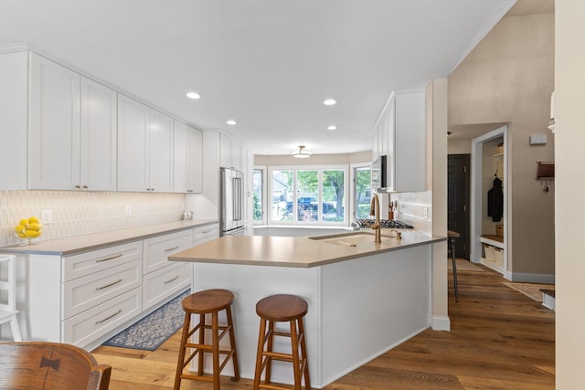 12816 95th Ave N, Maple Grove, MN 55369 - kitchen with appliances with stainless steel finishes, backsplash, recessed lighting, white cabinetry, and light wood-type flooring