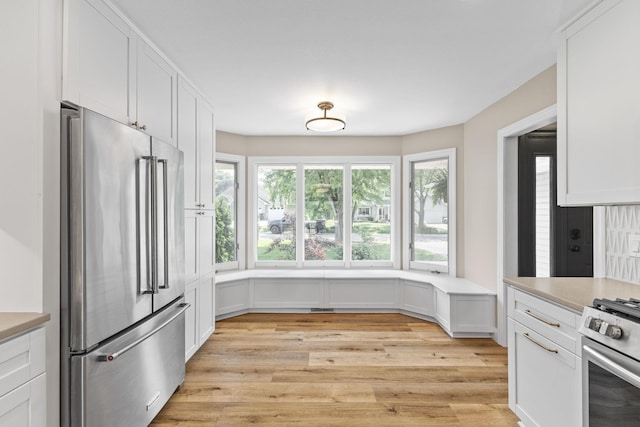 12816 95th Ave N, Maple Grove, MN 55369 - kitchen with appliances with stainless steel finishes, light wood-style flooring, light countertops, and white cabinetry
