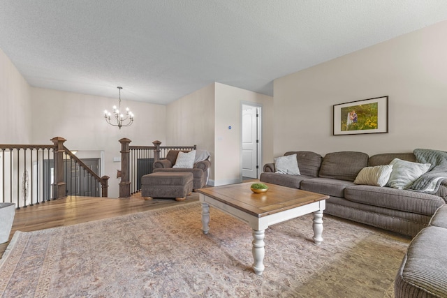 12816 95th Ave N, Maple Grove, MN 55369 - living room with wood finished floors, a chandelier, and a textured ceiling