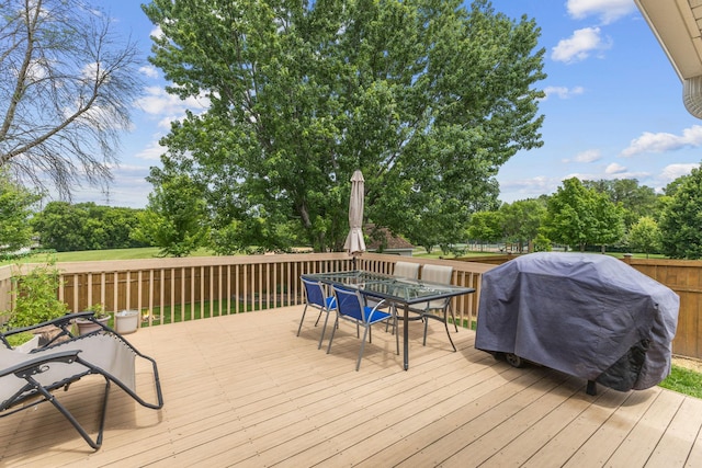 12816 95th Ave N, Maple Grove, MN 55369 - wooden deck featuring outdoor dining area, grilling area, and view of scattered trees