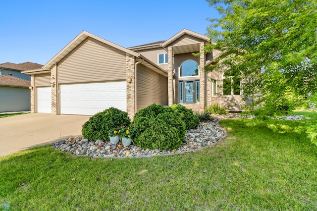 4375 58th St S, Fargo, ND 58104 - traditional-style home featuring an attached garage, concrete driveway, a front lawn, and brick siding