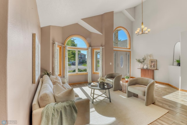 4375 58th St S, Fargo, ND 58104 - living room featuring high vaulted ceiling, wood finished floors, and a chandelier