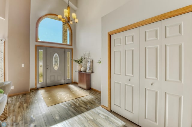 4375 58th St S, Fargo, ND 58104 - entrance foyer featuring a chandelier, light wood-style floors, and a towering ceiling