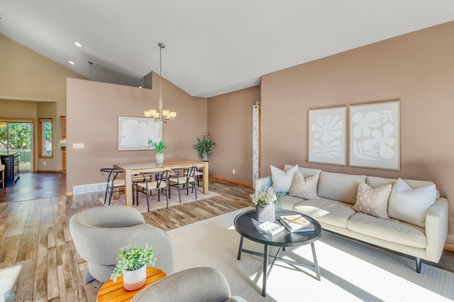 4375 58th St S, Fargo, ND 58104 - living room featuring a chandelier, wood finished floors, and high vaulted ceiling