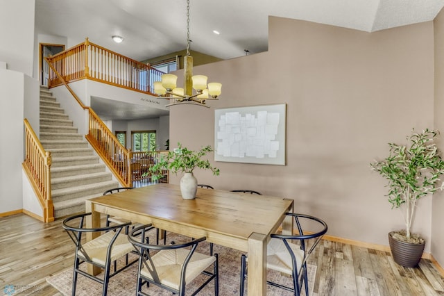 4375 58th St S, Fargo, ND 58104 - dining space with a chandelier, stairway, wood finished floors, and a high ceiling