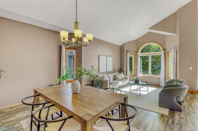4375 58th St S, Fargo, ND 58104 - dining room with a chandelier, light wood-type flooring, and high vaulted ceiling