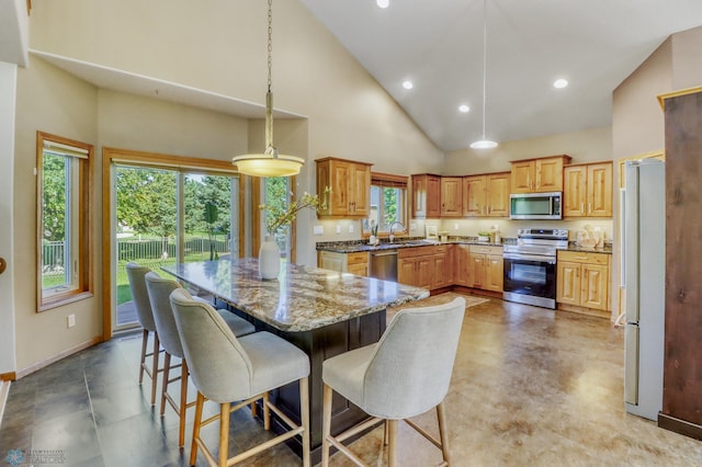 4375 58th St S, Fargo, ND 58104 - kitchen with appliances with stainless steel finishes, high vaulted ceiling, plenty of natural light, stone counters, and recessed lighting