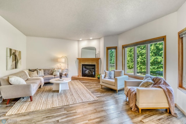 4375 58th St S, Fargo, ND 58104 - living room with a textured ceiling, hardwood / wood-style flooring, a fireplace, and recessed lighting