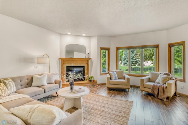 4375 58th St S, Fargo, ND 58104 - living area with a tile fireplace, a textured ceiling, hardwood / wood-style flooring, and recessed lighting
