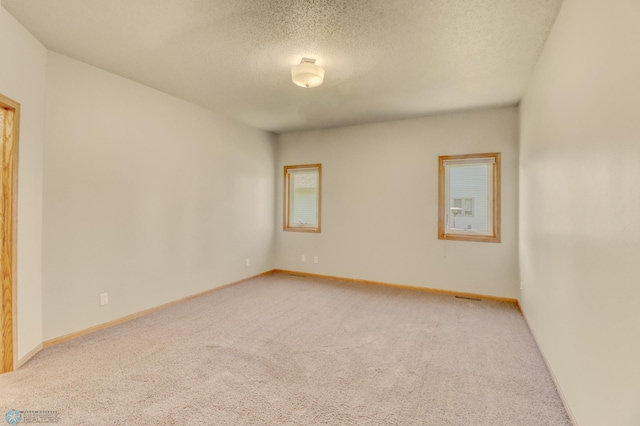 4375 58th St S, Fargo, ND 58104 - spare room with light colored carpet and a textured ceiling