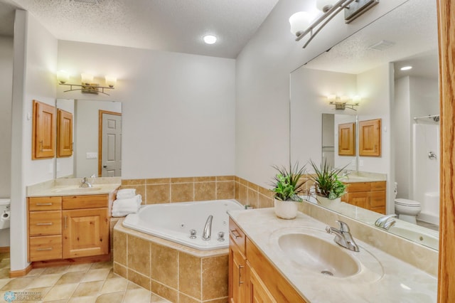 4375 58th St S, Fargo, ND 58104 - full bathroom featuring a jetted tub, two vanities, tile patterned floors, and a textured ceiling