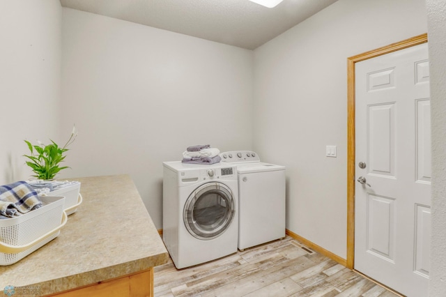4375 58th St S, Fargo, ND 58104 - laundry room featuring independent washer and dryer and light wood-style flooring