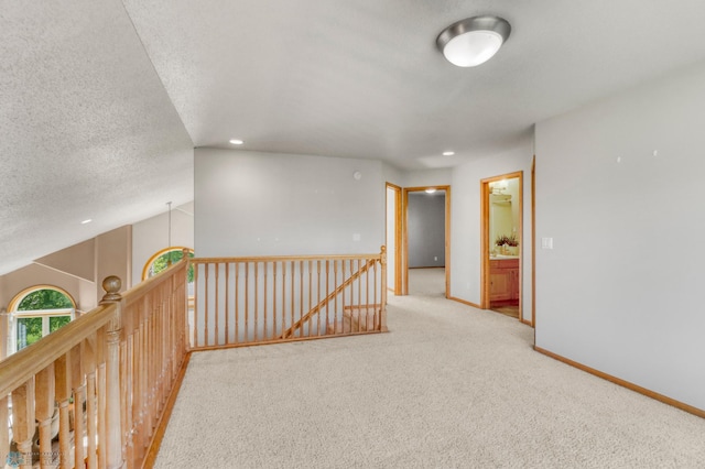 4375 58th St S, Fargo, ND 58104 - hallway with carpet flooring, a textured ceiling, recessed lighting, vaulted ceiling, and an upstairs landing