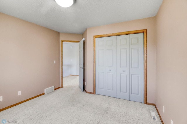 4375 58th St S, Fargo, ND 58104 - unfurnished bedroom with carpet, a textured ceiling, and a closet