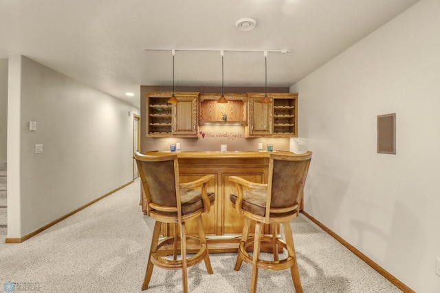 4375 58th St S, Fargo, ND 58104 - indoor wet bar featuring light carpet, hanging light fixtures, and rail lighting