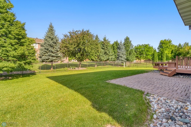 4375 58th St S, Fargo, ND 58104 - fenced backyard featuring a deck and a patio